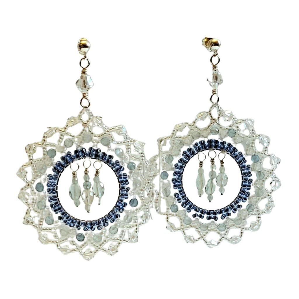 Intricately handcrafted by Fifi and the Peacock, a special pair of earrings on Sterling Silver post and butterfly fittings featuring various sizes of Aquamarine with Swarovski crystals with a Miyuki Seed Bead frame.