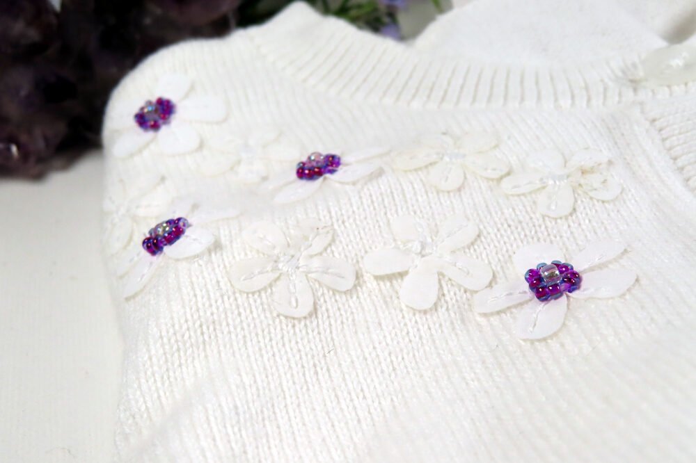 Picture of cardigan for Baby G showing the hand embellishment, by Fiona of Fifi and the Peacock, to match her mamas wedding dress and jewellery