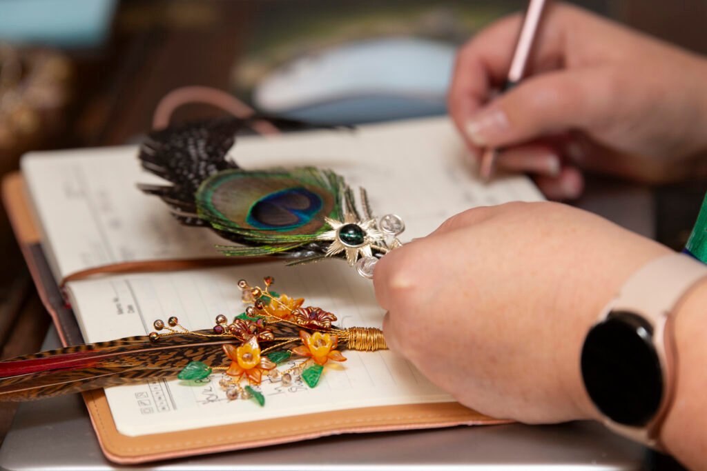 A picture of Fiona making notes for a customers design for a new piece of jewellery