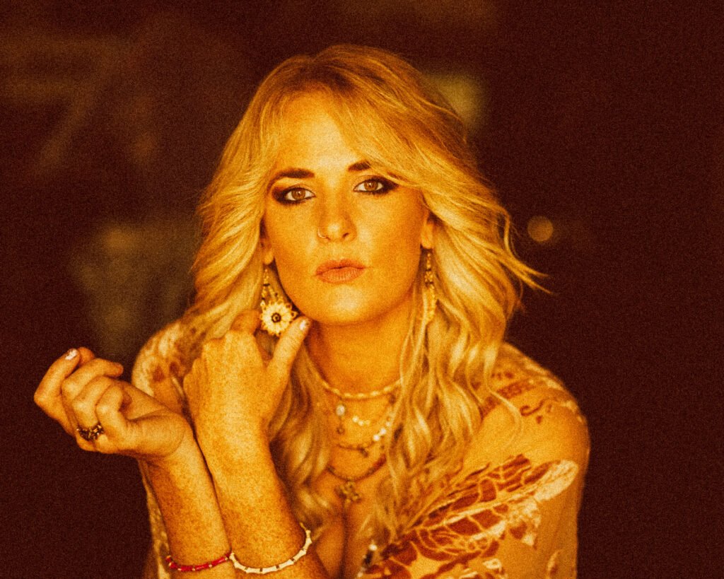 Picture of Elles Bailey wearing Fifi and the Peacock Sunflower earrings, taken in Somerset in June 2025 by Blackham Images