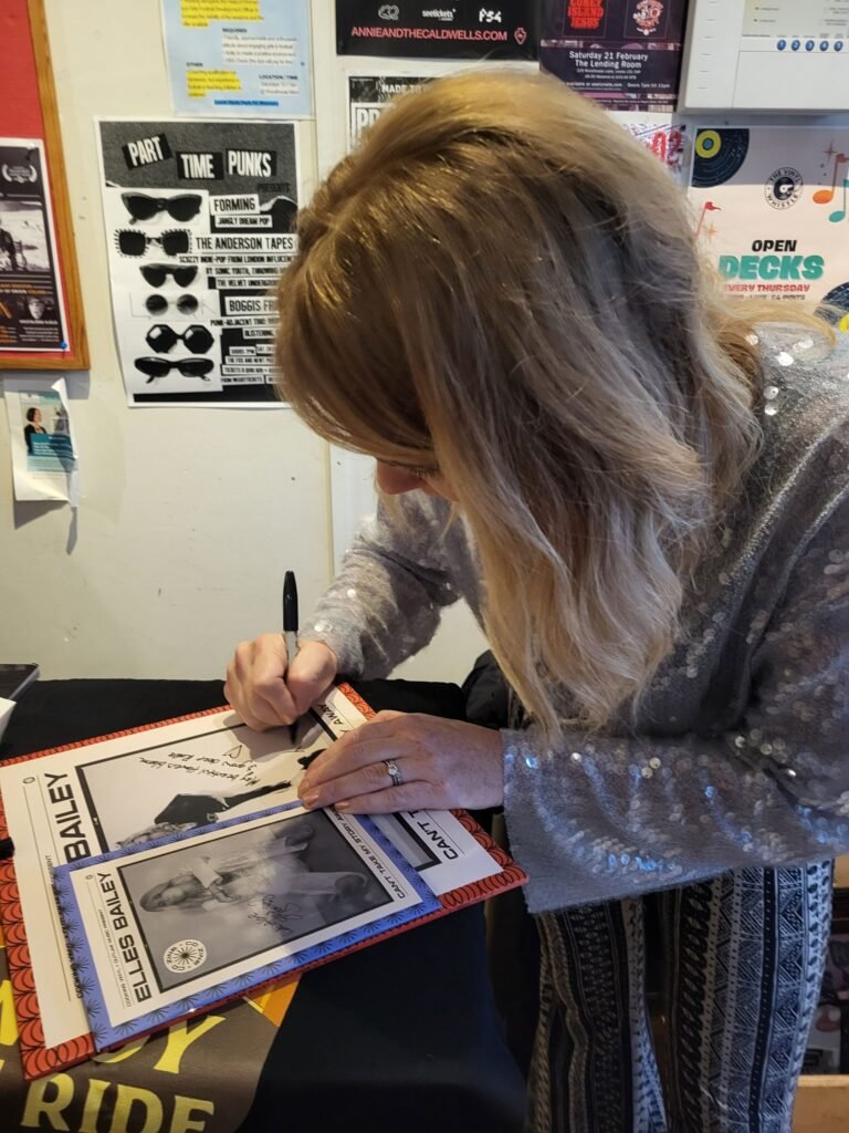 Elles Bailey signing her album Can't Take My Story Away at The Vinyl Whistle in Leeds as part of her record store shows for the album release.  The album cover has a picture of Elles Bailey wearing the signature Sunflower Earrings designed and crafted by Fiona of Fifi and the Peacock