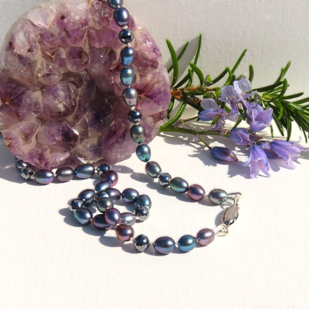 Peacock coloured Cultured Freshwater Pearls have been strung with faceted Terahertz for this modern take on a classic pearl necklace.  Traditionally strung with a  sterling silver clasp.  Can be worn by  any gender.   Designed and crafted by Fiona of Fifi and the Peacock