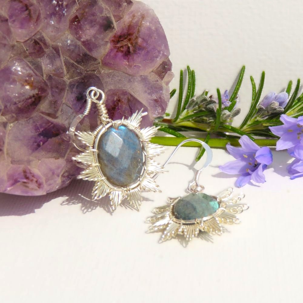 Part of the Sunburst collection.  Faceted Labradorite oval beads are surrounded by silver plated copper wire in a sunburst design.  Suspended from sterling silver ear wires.  Designed and crafted by Fiona of Fifi and the Peacock