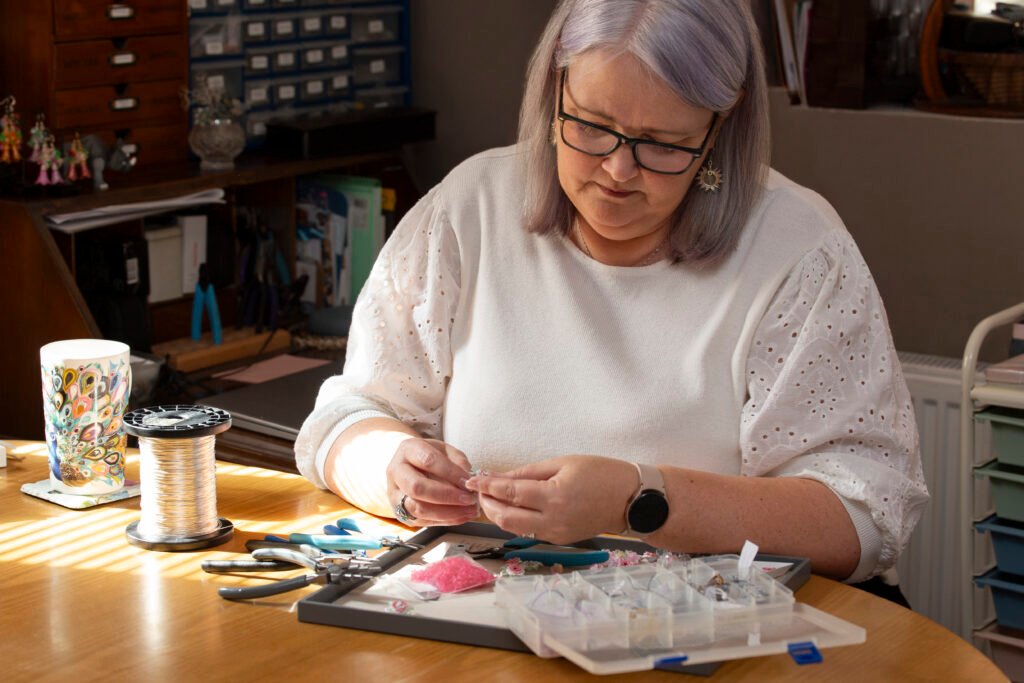 Picture shows Fiona of Fifi and the Peacock working on new designs.  