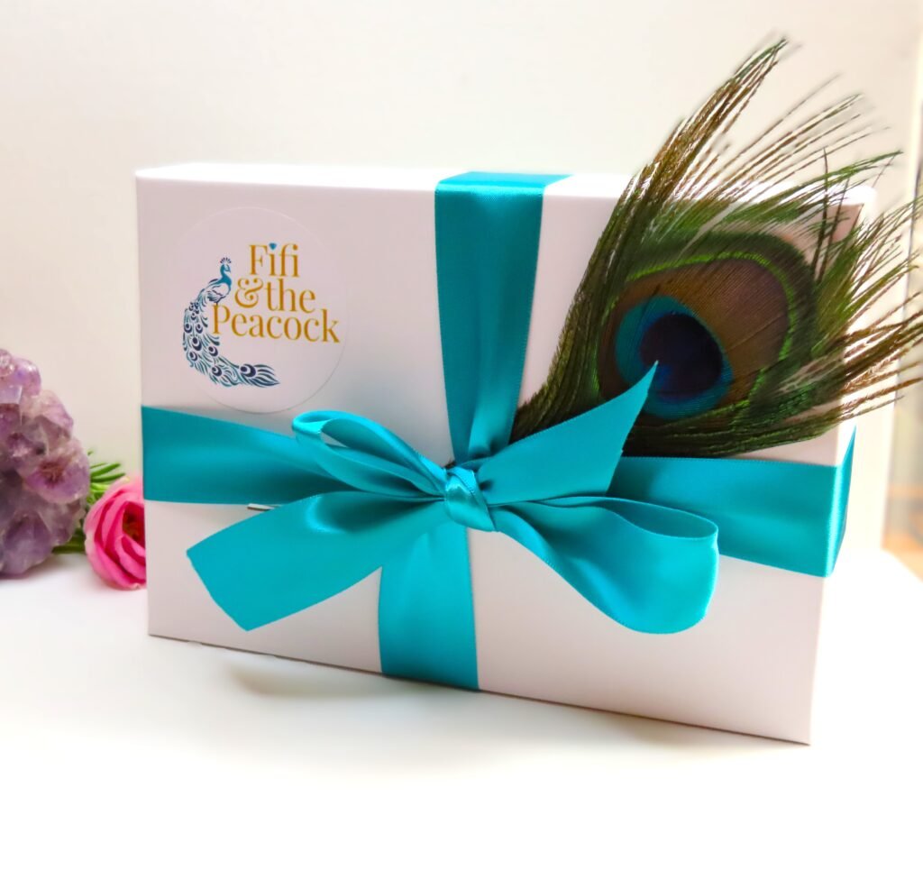 Packaging for Prom Jewellery - a beautiful white box finished with co-ordinating ribbon and Peacock Feather from Fifi and the Peacock.  Perfect for keeping Prom momentoes.