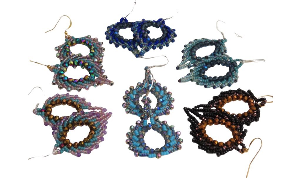 Selection Peacock Feather earrings, designed and crafted by Fiona of Fifi and the Peacock with Miyuki seed beads, faceted glass crystals and toning genuine gemstones.  These form part of the Peacock and Plume Collection.