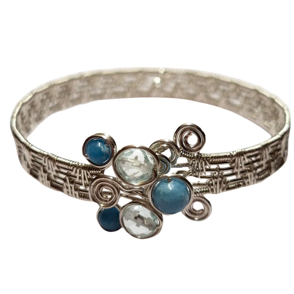 Double fan weave cuff in silver plated copper wire featuring Larimar and faceted Sea Glass made as a custom design for a 60th Birthday